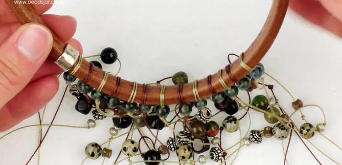 Attach dimpled beads: Slide a dimpled bead onto each leather end of the Regal's bracelet band.