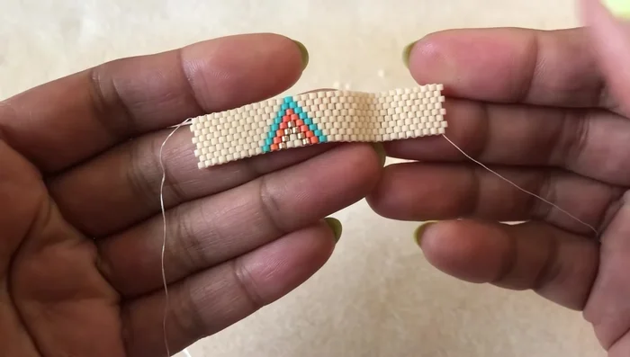 Size your ring: Wrap the ring around your finger to check the size. Add more rows if needed to ensure a comfortable fit and that the up beads on one end fit snugly into the down beads on the other.