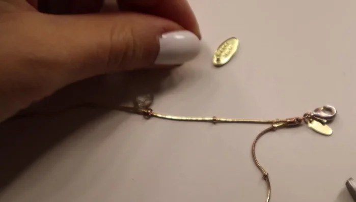 Open jump rings using pliers.