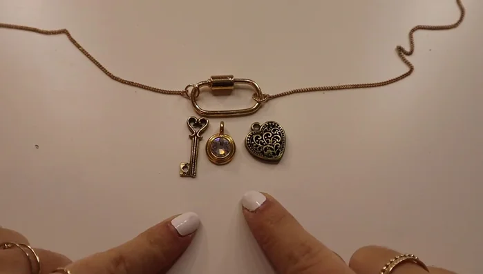 Attach charms to the chain using jump rings.