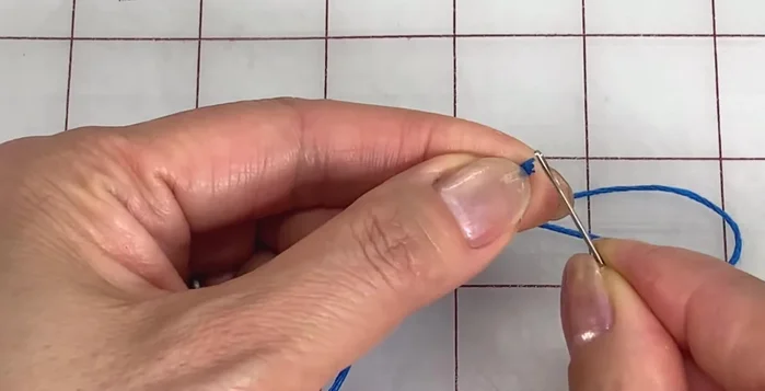 Thread the tassel through a sleeve again and push it down to your desired length. Trim the ends using sharp scissors.