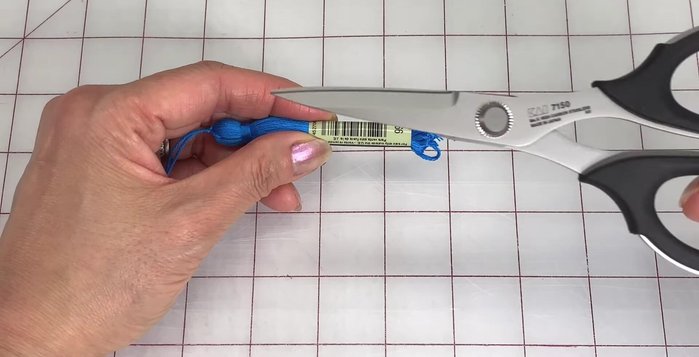 Thread the tassel through a sleeve again and push it down to your desired length. Trim the ends using sharp scissors.