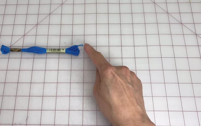 Fold one strand in half and tie a loop at the top (about 2 inches or 5 centimeters long).