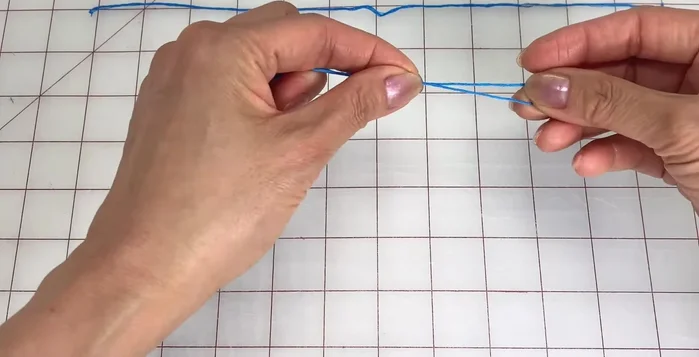 Fold one strand in half and tie a loop at the top (about 2 inches or 5 centimeters long).