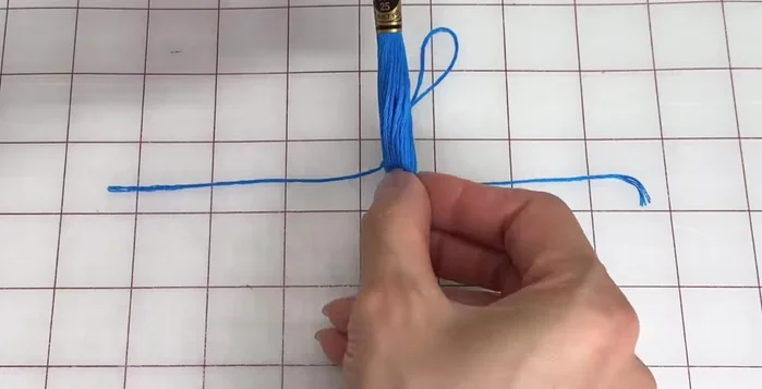 Remove the sleeves from each end, fold in half again, and pull up on the top loop.