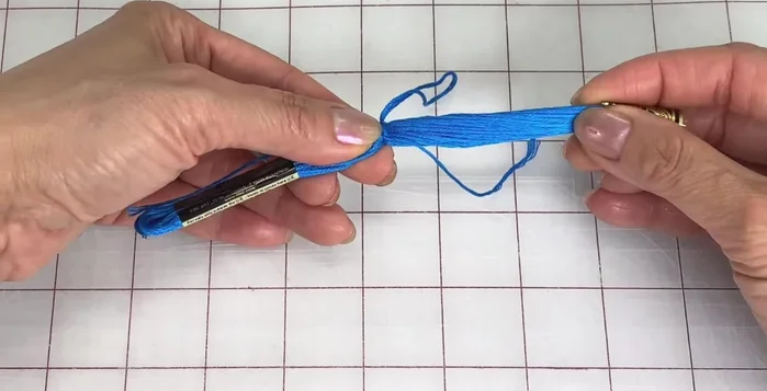 Remove the sleeves from each end, fold in half again, and pull up on the top loop.