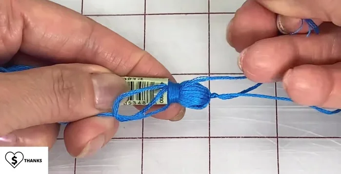 Thread the end through the loop and pull the top strand to close it up. Remove the sleeve and pull on the top strand until the loop disappears.