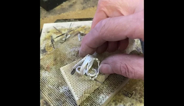 Solder the tube setting into the piece using easy solder.