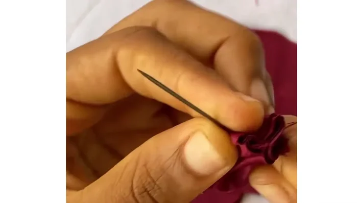 Repeat the loose stitch process for all eight petals, creating an in-out-in-out stitch pattern.