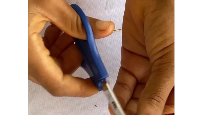 Glue the pin to the back of the flower. Cover the pin with another small piece of fabric (or felt) to conceal it, securing it with glue.