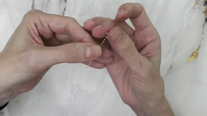 Start with a head pin. Add a 2mm spacer bead (to prevent the larger bead from popping over).