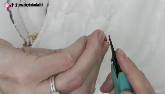 Twist the tail around a few times, trim the extra, and tuck the end down.