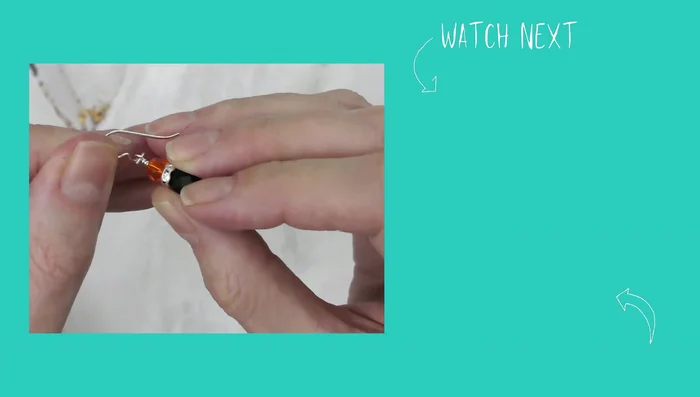 Add the ear wire using bent chain nose pliers. Twist the loop to the side, slide on the dangle, and twist the loop closed.