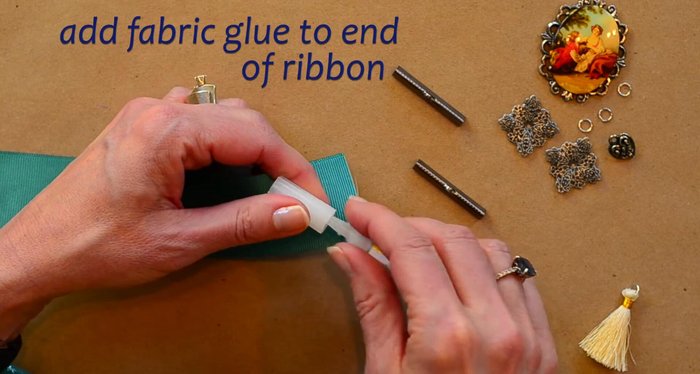 Secure the crimp ends onto the ribbon using flat nose pliers. Press firmly to compress the crimp end and secure it to the ribbon.