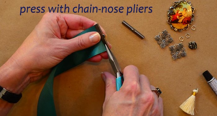 Secure the crimp ends onto the ribbon using flat nose pliers. Press firmly to compress the crimp end and secure it to the ribbon.