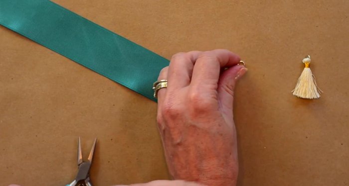Attach a tassel to the other end of the ribbon using the same jump ring technique as steps 5 and 6.