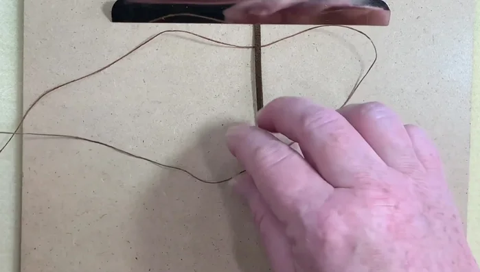 Tighten the knot, ensuring even tension on both sides.