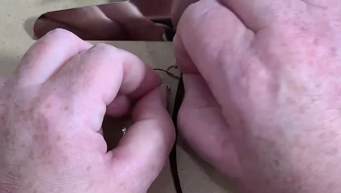 Continue adding beads and repeating the 'P' and 'Q' macrame pattern until desired length is reached. Maintain even spacing of beads and chain.