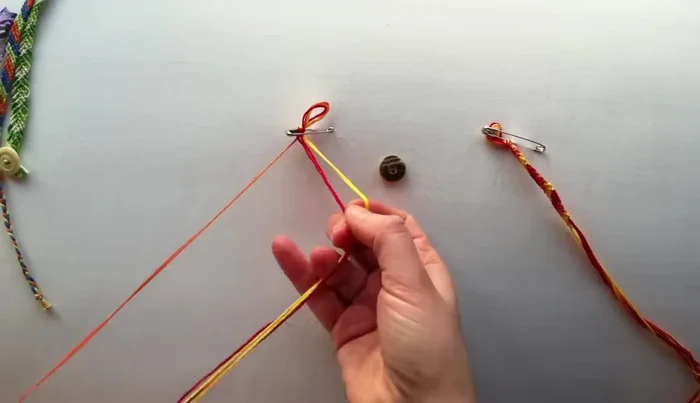 Arrange your floss: Arrange the three strands neatly. The order doesn't matter initially.