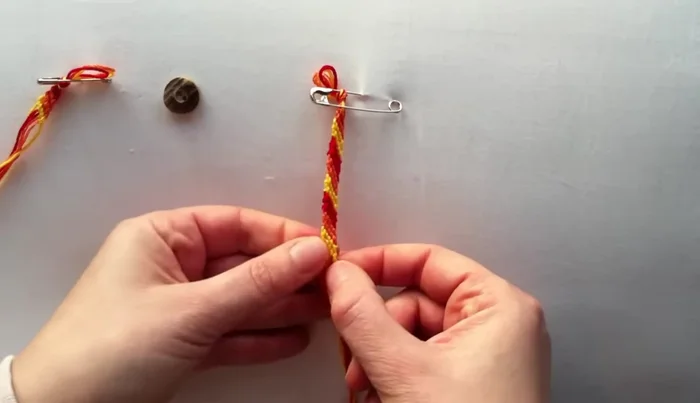 Maintain tension: Push up the knots as you go to keep the bracelet neat and tight.