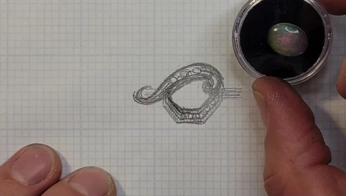 Draw in the blue topaz settings on the upper section of the ring.