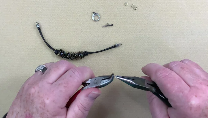 Attach the toggle clasp: Attach the toggle clasp using jump rings; using three jump rings on one side to provide extra stability.