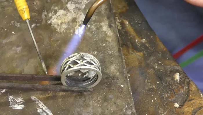 Finishing: Clean the rings, refine the shape, and polish using emery, brownie disc, and greeny polishing disc. Use a tumbler for final polishing.