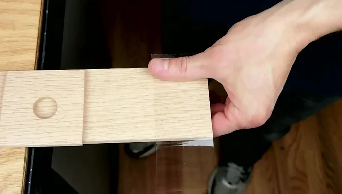 Clamp the two pieces of wood together to form a mold.