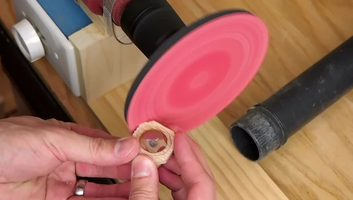 Sand the sides and edges of the wood round, apply several coats of shellac.