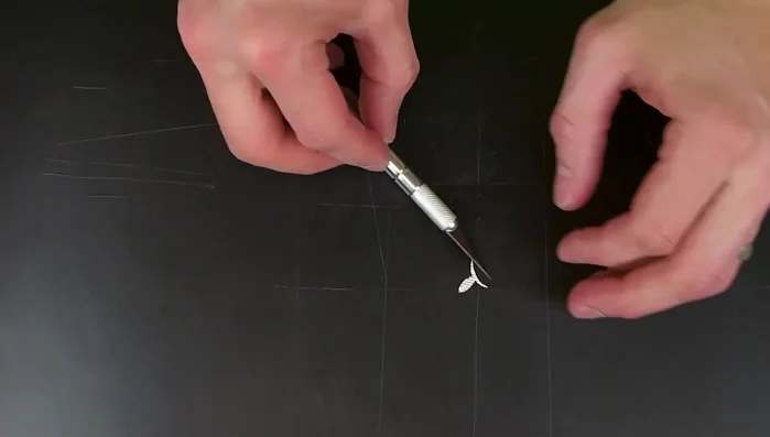 Seal the paper flower with Mod Podge to prevent staining during resin embedding (apply about four coats).