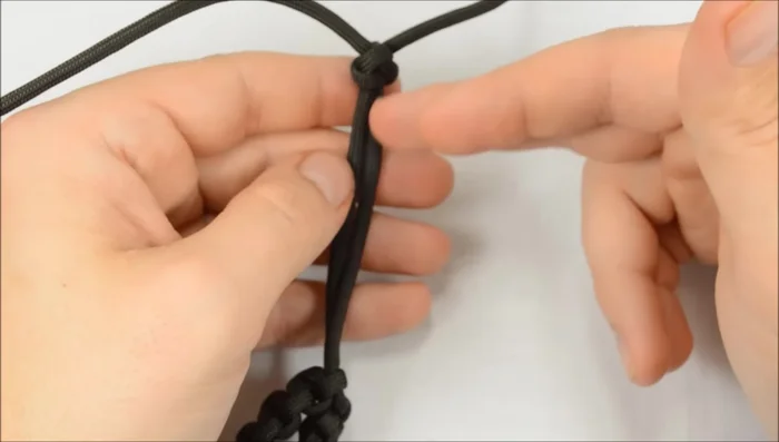 Adjust the stopper knot: If the stopper knot is too far out, loosen the bracelet and work the knot down to the desired position.
