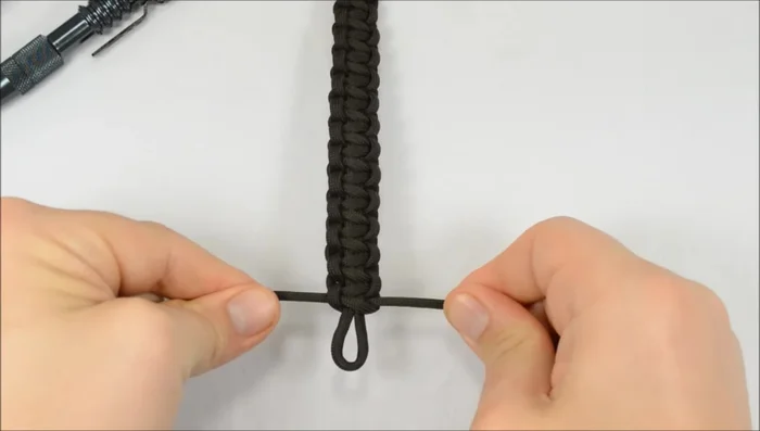 Secure the end loop: Run one cord through the final loop, then continue the stitch, bringing the other cord up through the loop and tightening the knot.