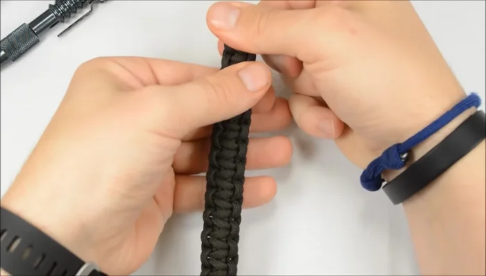 Secure the end loop: Run one cord through the final loop, then continue the stitch, bringing the other cord up through the loop and tightening the knot.