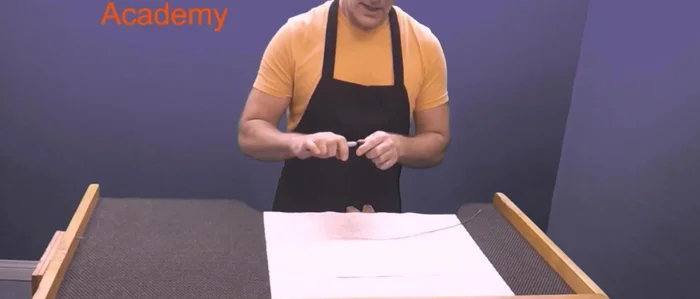 Create the initial bend: Form a large 'L' shape with the wire.