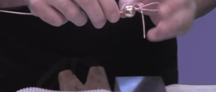 Add beads (optional): Slide beads onto the wire at desired locations, creating loops to hold them in place.