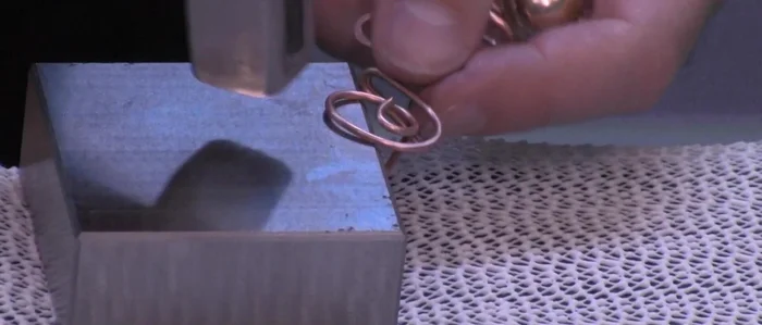 Secure the final spiral: Hammer the final spiral to lock the shape firmly in place.