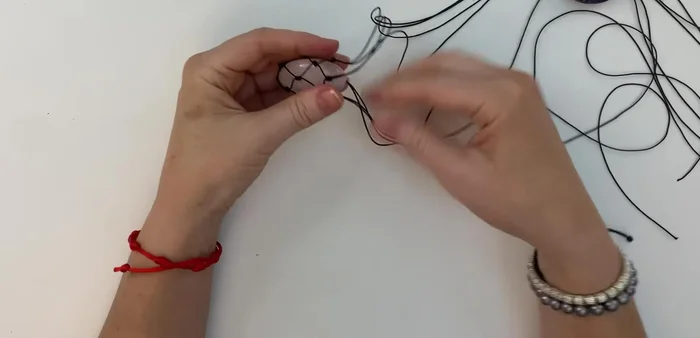 Create necklace straps: Join the four threads on each side of the netting.