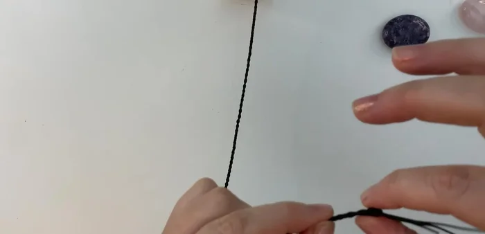 Add beads and secure braids: Once braided, add the large-holed bead to each strand and secure with a simple knot.