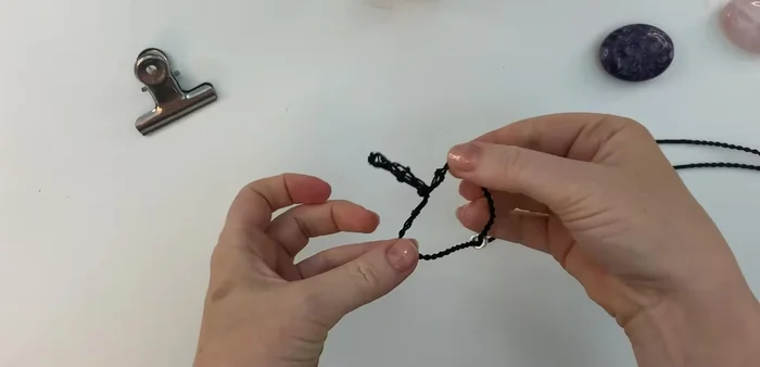 Insert crystal: Slide the bead up, gently open the netting, insert the crystal, and slide the bead back down to secure it.