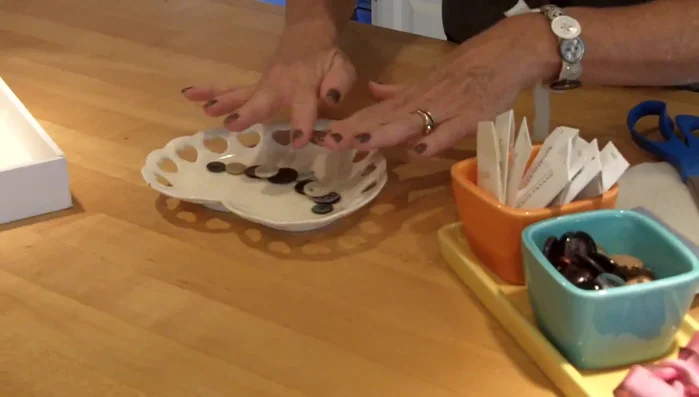 Gather your buttons and arrange them in the desired order for your necklace.