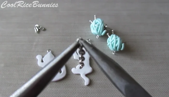 Assemble the earrings: Attach chains to the eye pins using pliers and jump rings (optional). Add stud earrings to the back of the yarn balls if desired.