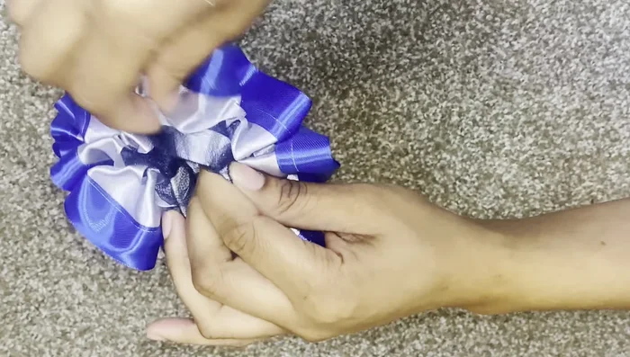 Finish and neaten: Evenly distribute the ribbon and tool along the elastic, trimming any excess ribbon and burning the ends to prevent fraying.