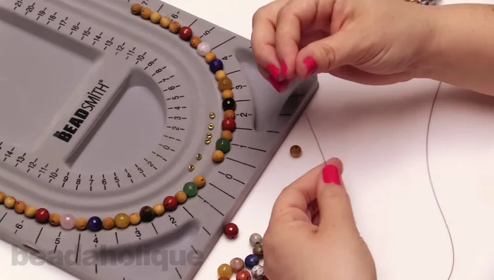 Add beads to one side until reaching the desired length. Add a bead stopper to this end.