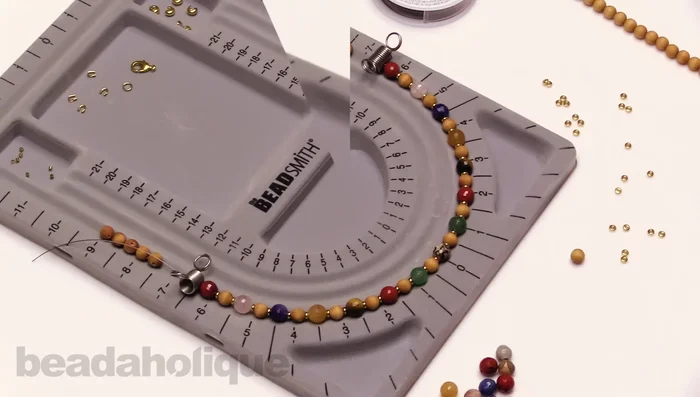 String the beads for the other side of the necklace, mirroring your design. Use the bead board to ensure consistent spacing and design.