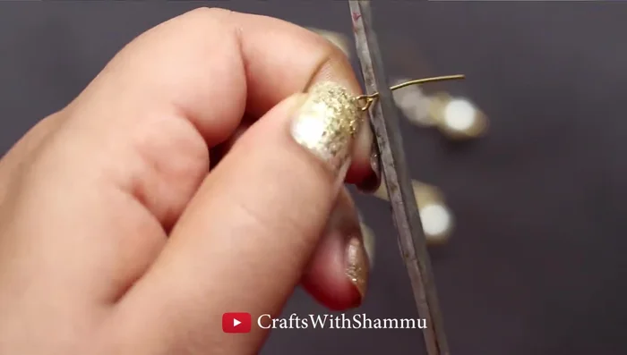 Cut off excess pin after attaching pearls.