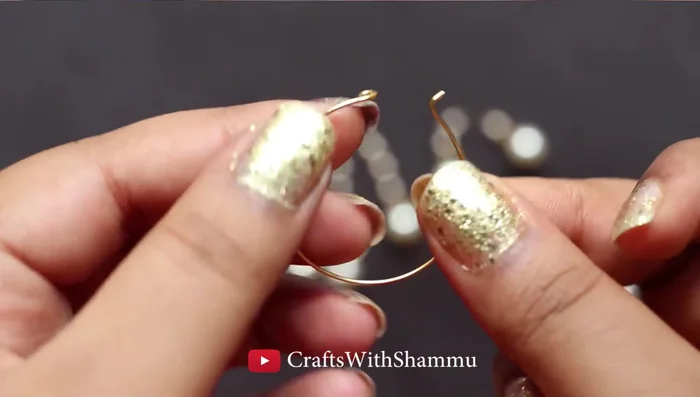 Bend the ends of the hoop earrings straight to insert beads.