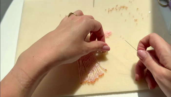 Create the fringe. Prepare strands of seed beads and crystals in a repeating pattern (e.g., three pink, three silver, three ivory). 