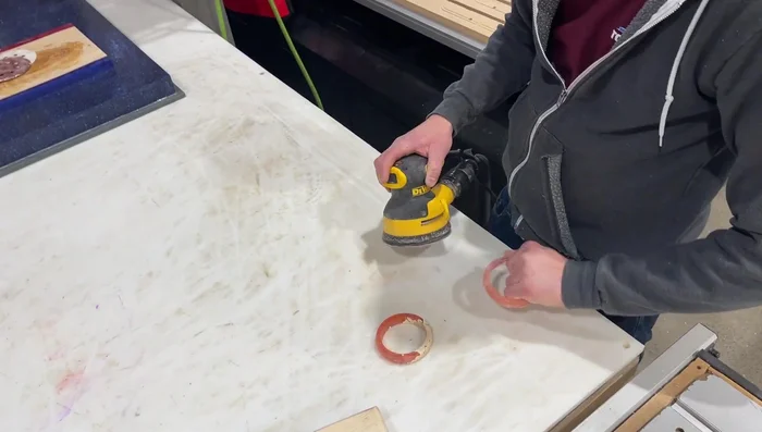 Sand the bracelets using palm sander and sponge sandpaper (80-400 grit), progressing through different grits for a smooth finish. Wet sanding can be added for extra smoothness.