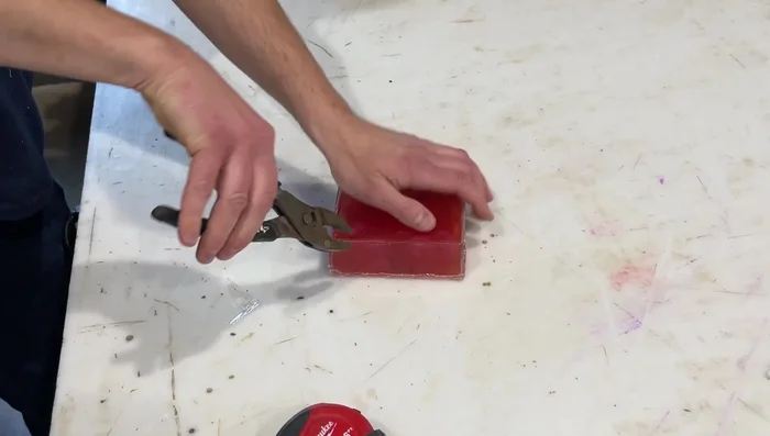 Let the resin cure completely.