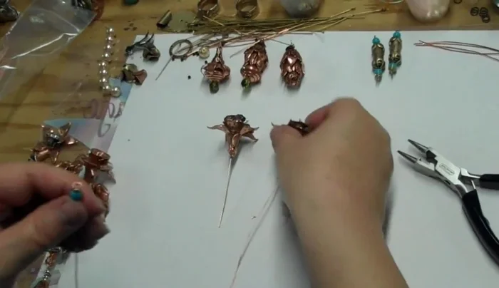 Assemble the flower: Attach flower components (cups, petals, etc.) to the squiggly wire.